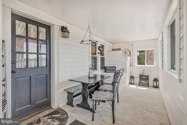 a view of a patio with couches table and chairs and potted plants