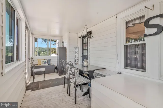 an outdoor sitting area with couch and wooden fence