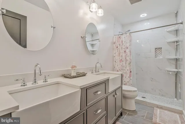a view of a hallway with wooden floor and windows