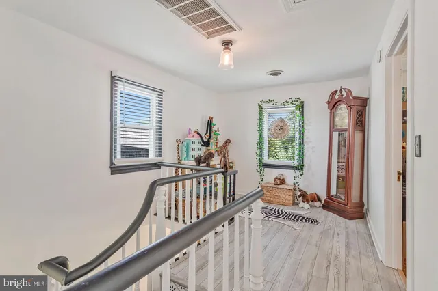 a bathroom with a sink a toilet and a window