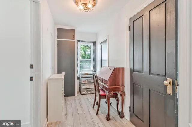 a bedroom with furniture wooden floor and a window