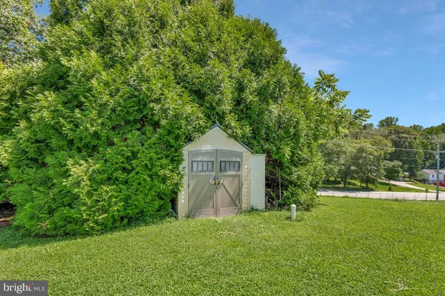 a backyard of a house with plants and trees