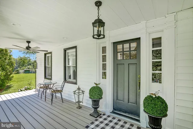 a view of a livingroom with furniture and hardwood floor