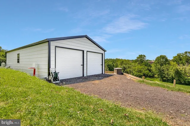 a view of a grassy field with trees