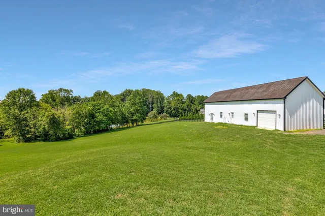 a view of a house with a yard plants and a patio