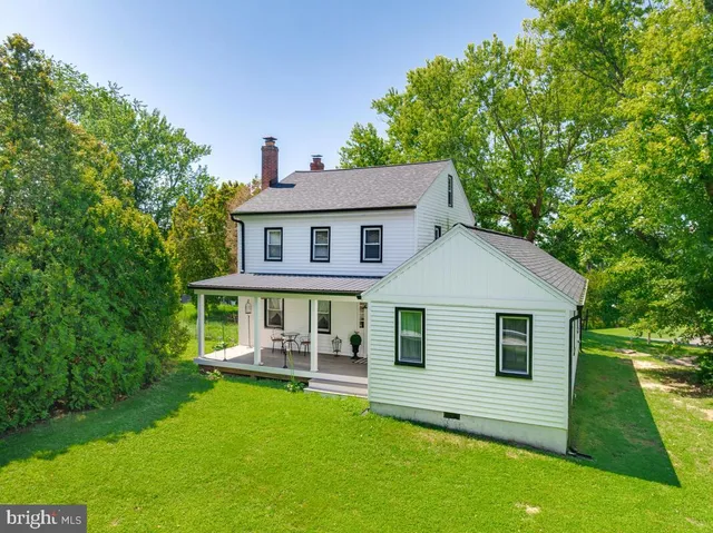 a view of a backyard with a garden and tree