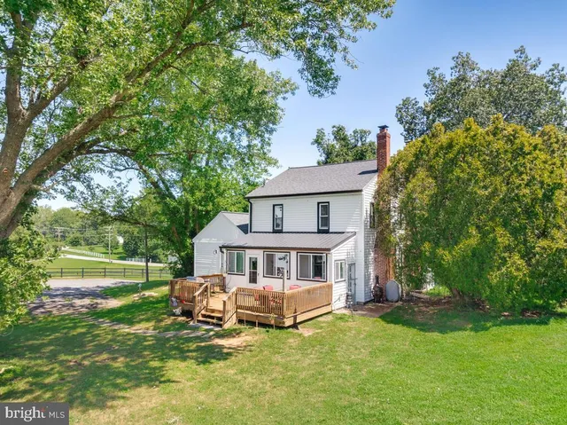 an aerial view of a residential houses with yard