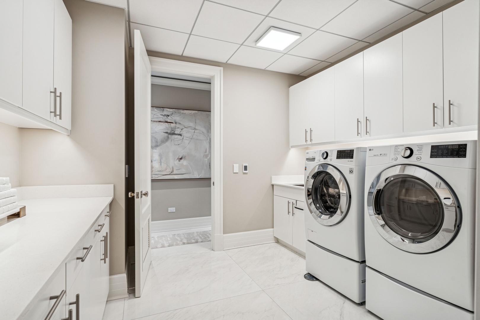9 West Walton Street, Unit 2802 Chicago, IL 60610 - Photo 31 of 44 a utility room with sink dryer and washer