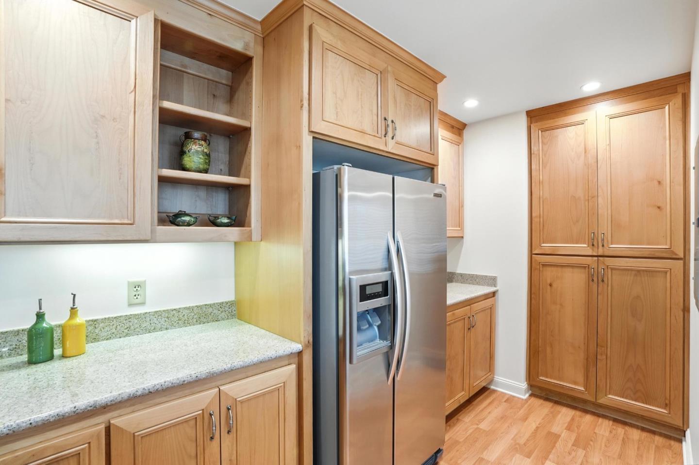 10 Crystal Springs Road, Unit 1507 San Mateo, CA 94402 - Photo 13 of 33 a kitchen with stainless steel appliances granite countertop a refrigerator and a sink