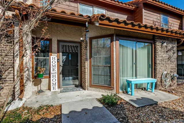 a view of a chair and table in the patio