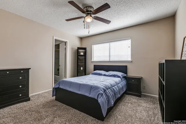 a bedroom with a bed and a dresser