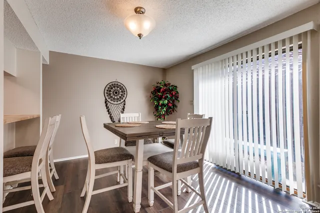 a view of a dining room with furniture and chandelier