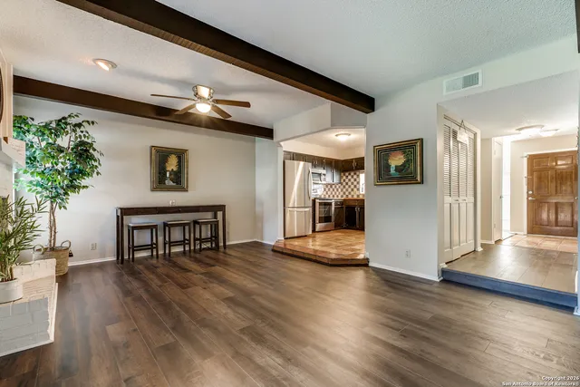 a view of a livingroom with furniture and a kitchen