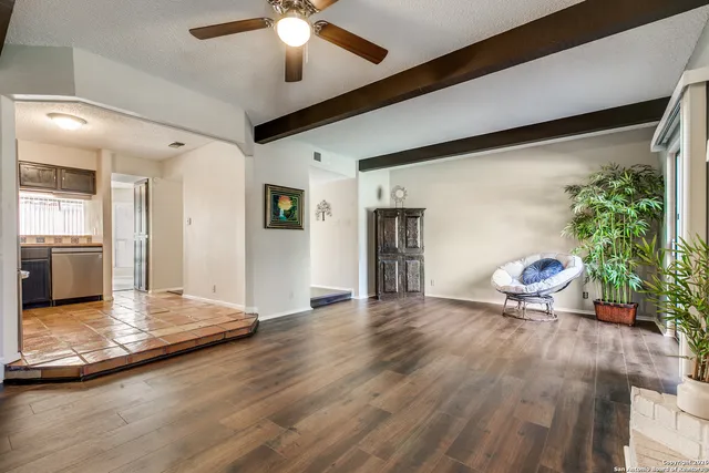 a view of a livingroom with kitchen and furniture