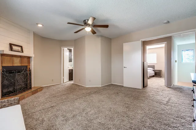 a view of empty room with window and fireplace