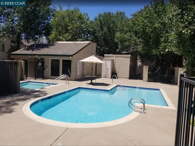 a view of a house with swimming pool and porch