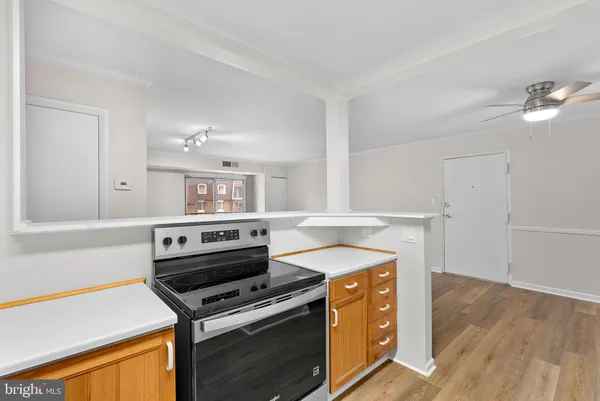 a view of large kitchen with a sink and wooden floor
