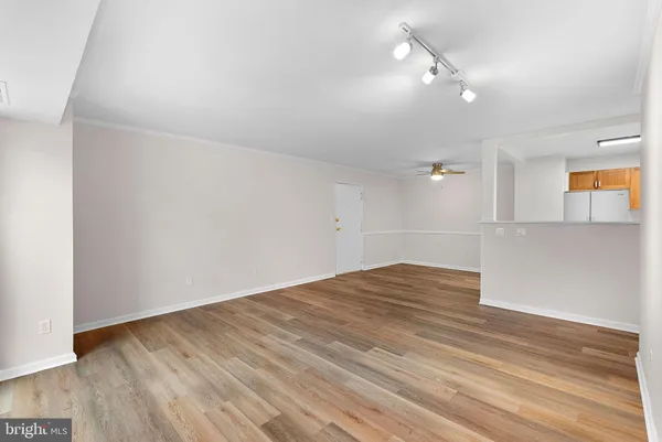 a view of empty room with wooden floor