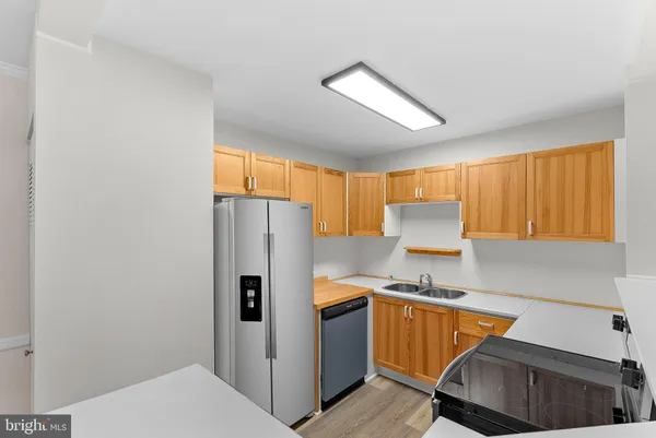 a kitchen with stainless steel appliances a refrigerator and a stove top oven