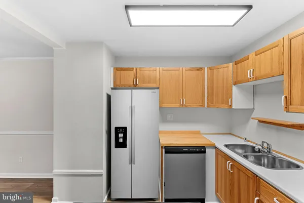 a kitchen with a refrigerator and a sink