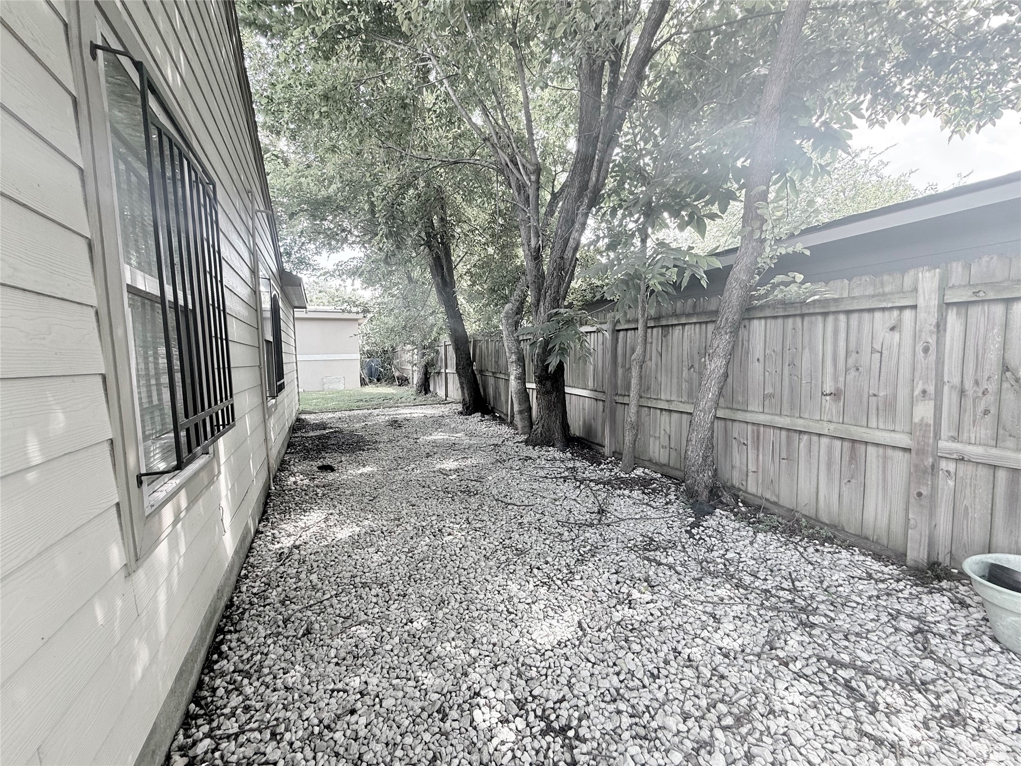 5103 Northridge Drive Houston, TX 77033 - Photo 13 of 39 a view of a backyard with wooden fence and large trees