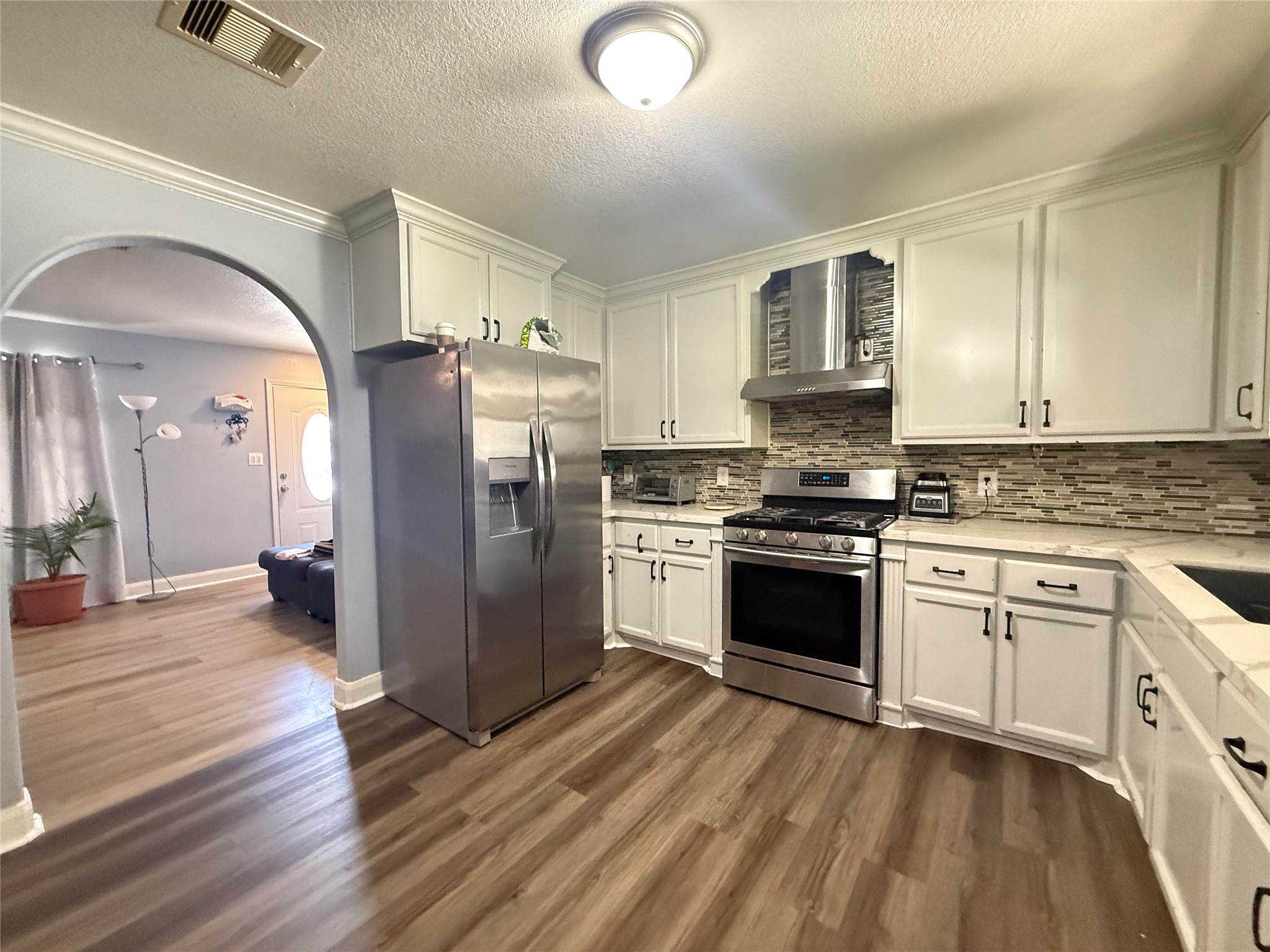 5103 Northridge Drive Houston, TX 77033 - Photo 22 of 39 a kitchen with granite countertop a refrigerator stove top oven and sink