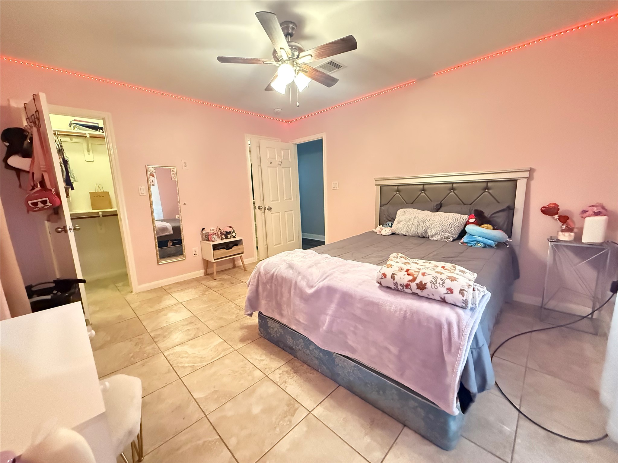 5103 Northridge Drive Houston, TX 77033 - Photo 24 of 39 a bedroom with a large bed and a chandelier