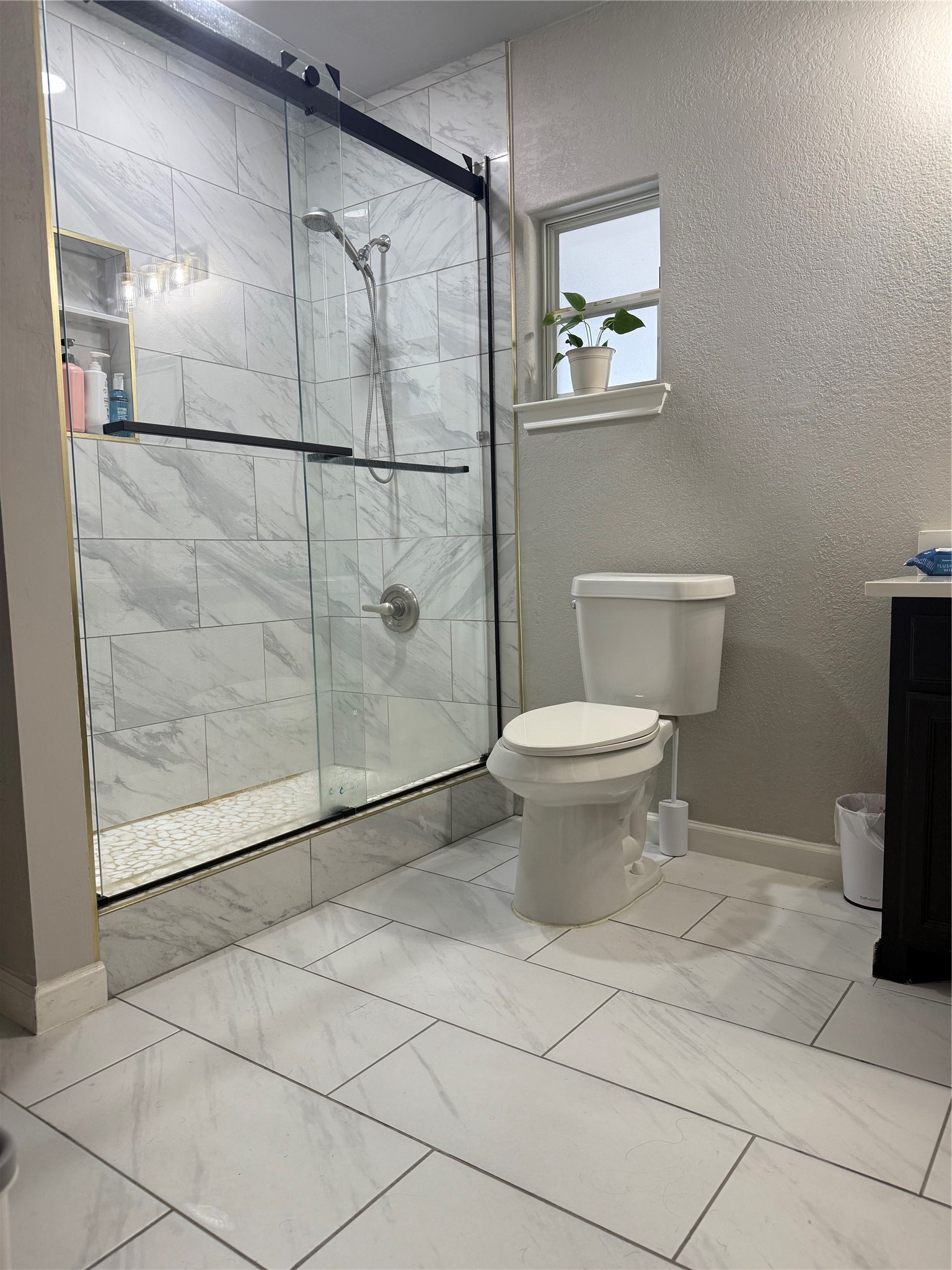 5103 Northridge Drive Houston, TX 77033 - Photo 31 of 39 a bathroom with a toilet and a shower