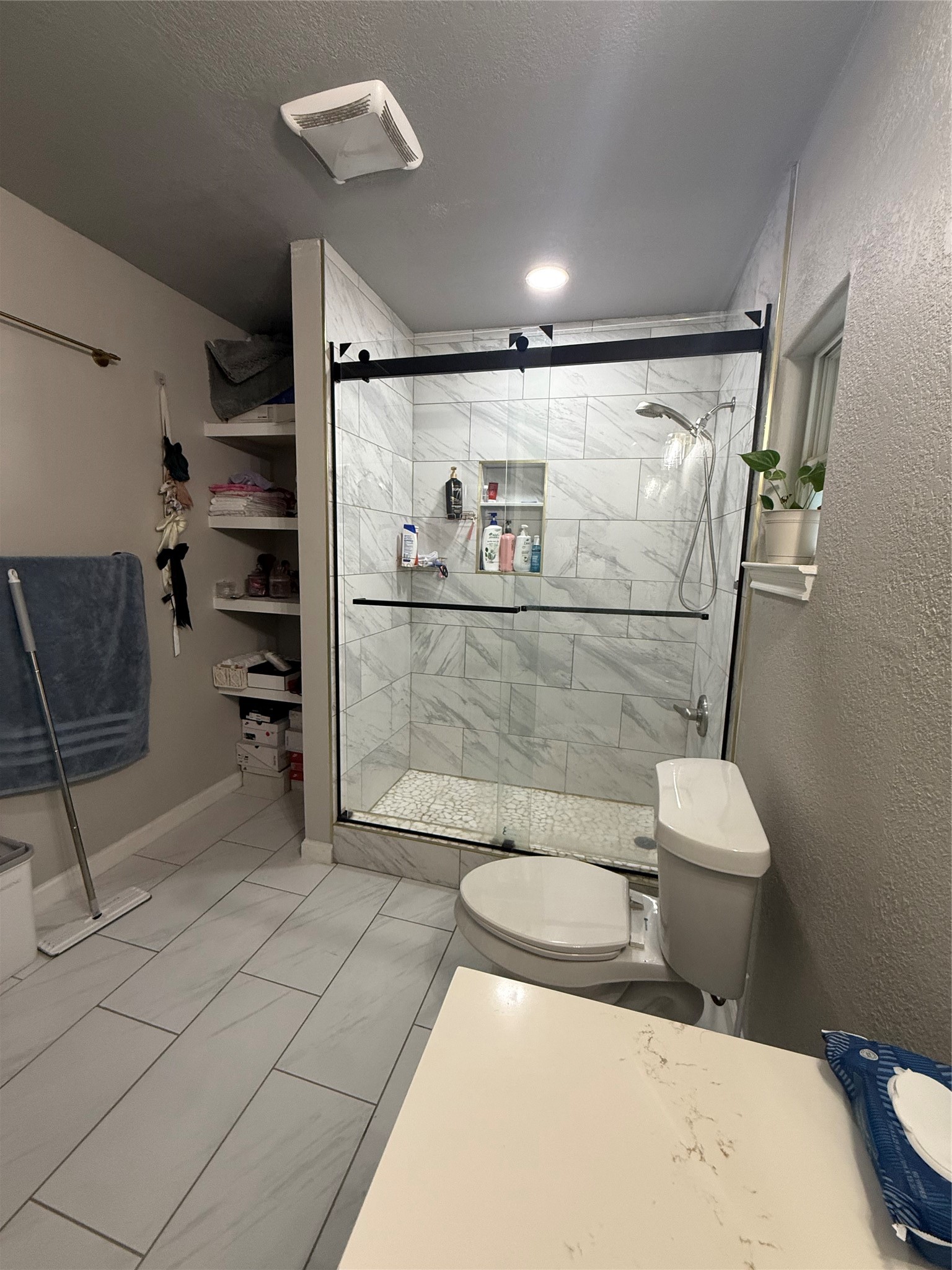 5103 Northridge Drive Houston, TX 77033 - Photo 32 of 39 a bathroom with a toilet and a shower