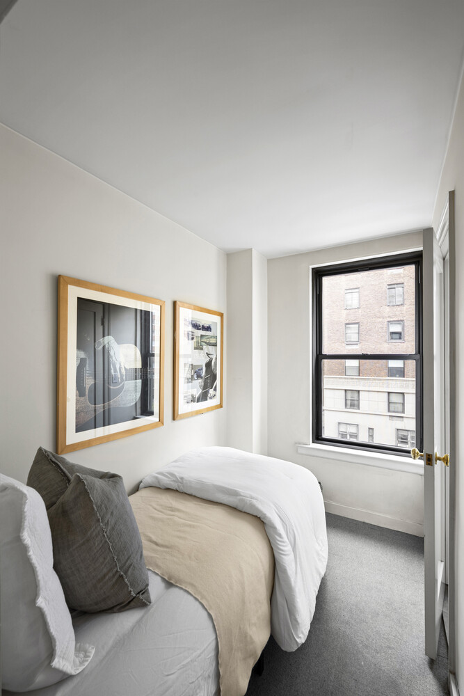 25 East 86th Street, Unit 4B Manhattan, NY 10028 - Photo 10 of 16 a bedroom with a bed and a large window