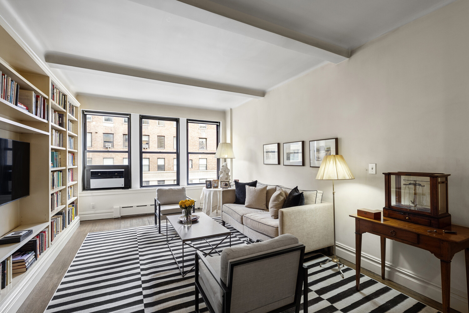25 East 86th Street, Unit 4B Manhattan, NY 10028 - Photo 7 of 16 a living room with furniture fireplace and a flat screen tv