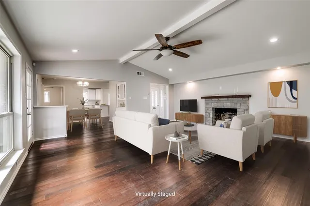 a living room with fireplace furniture and a wooden floor