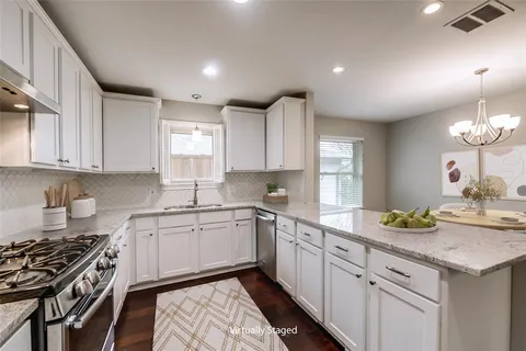 a kitchen with a sink stove and cabinets