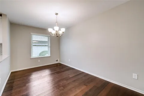 a view of a room with wooden floor and window