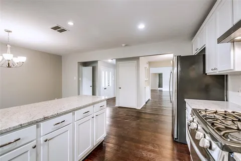 a open kitchen with sink and cabinets
