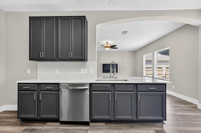 a kitchen with a sink and cabinets