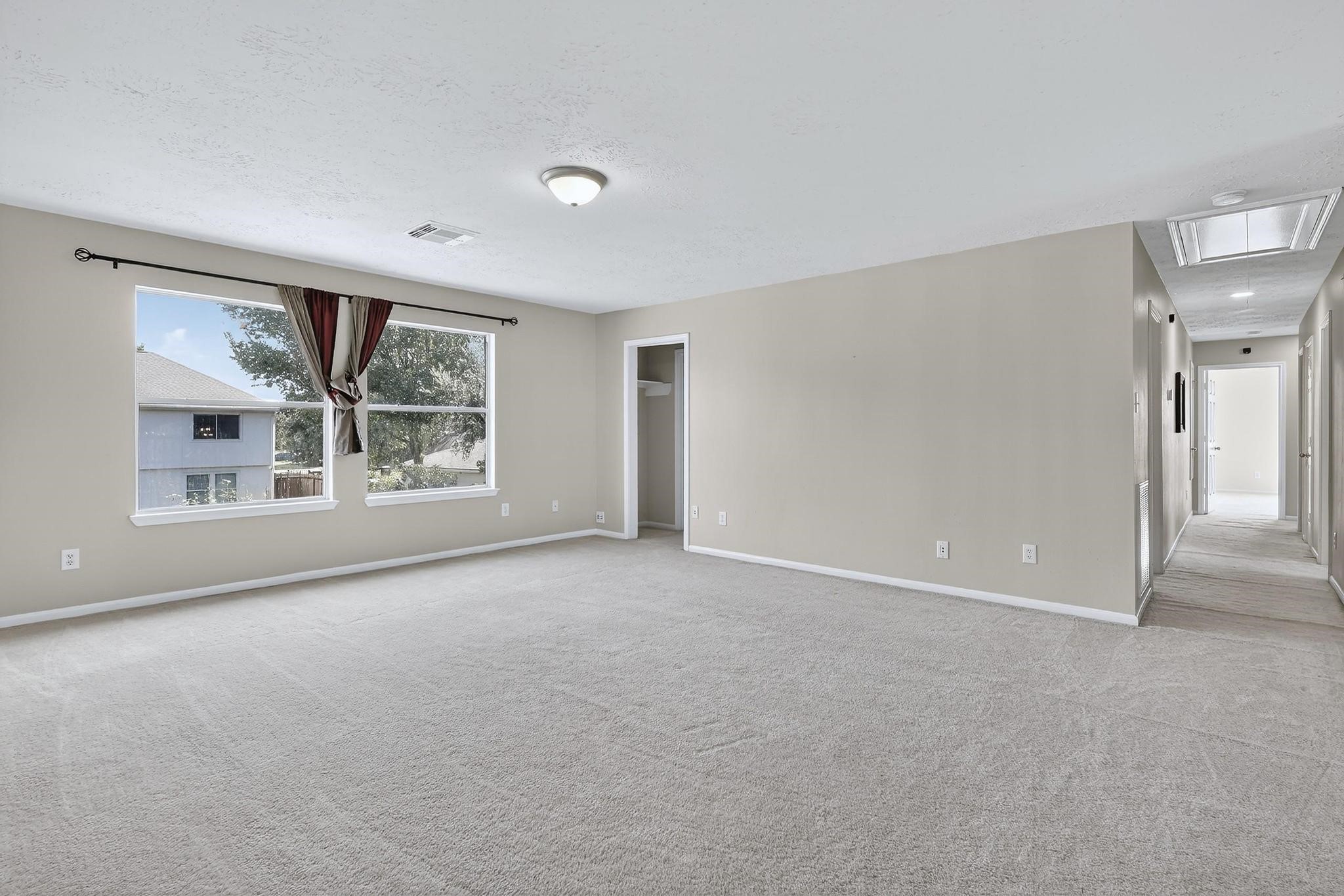 20926 Trellis Lane Houston, TX 77073 - Photo 17 of 24 a view of a big room with windows and chandelier fan