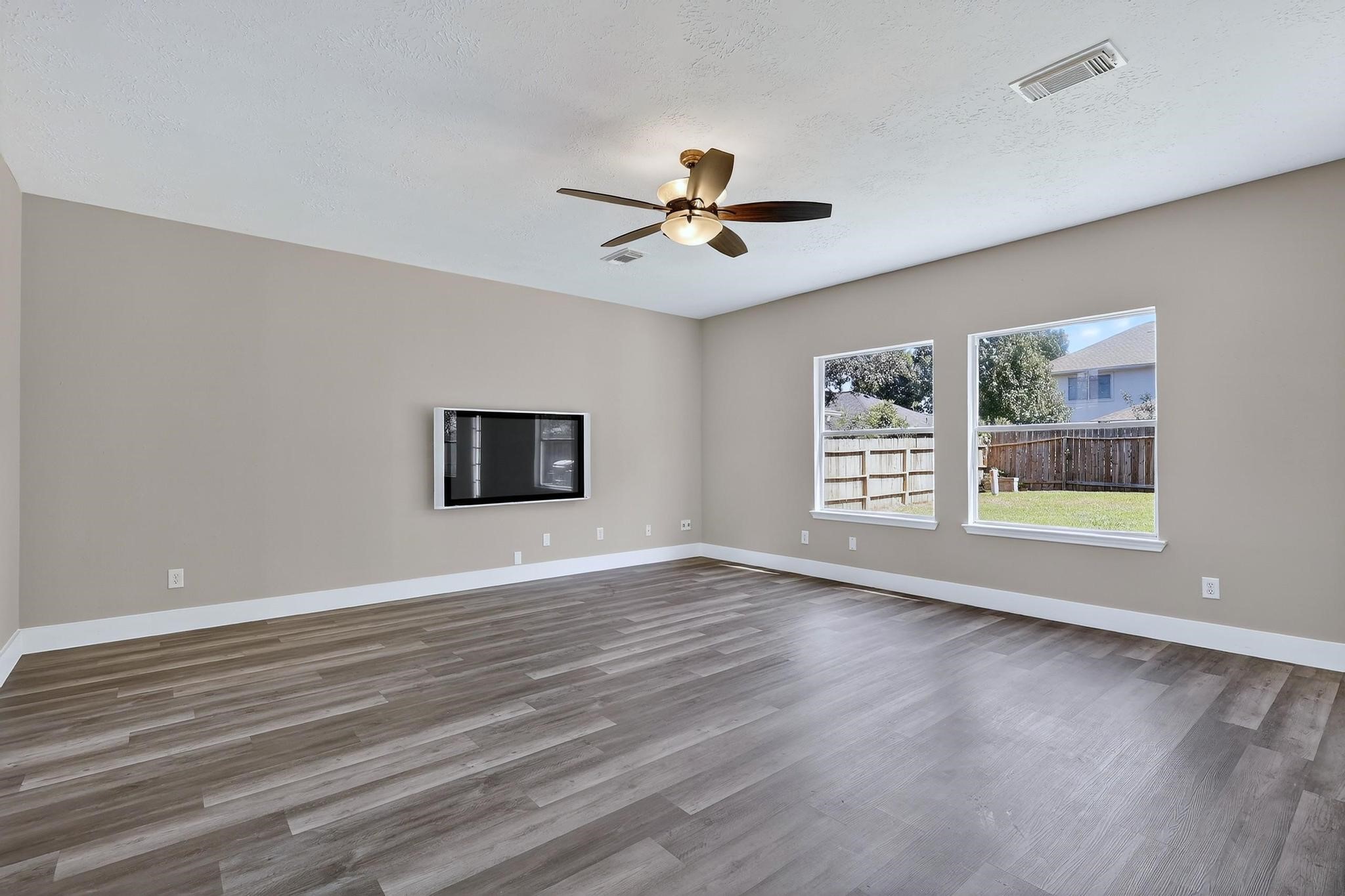 20926 Trellis Lane Houston, TX 77073 - Photo 3 of 24 a view of an empty room with a window and wooden floor