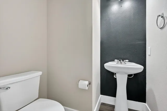a bathroom with a sink toilet and a mirror