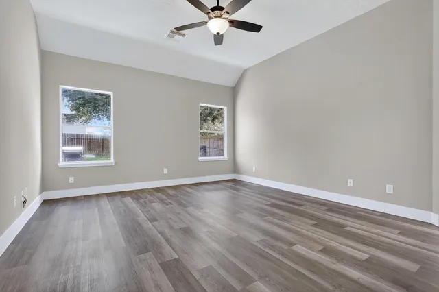 wooden floor in an empty room with a window