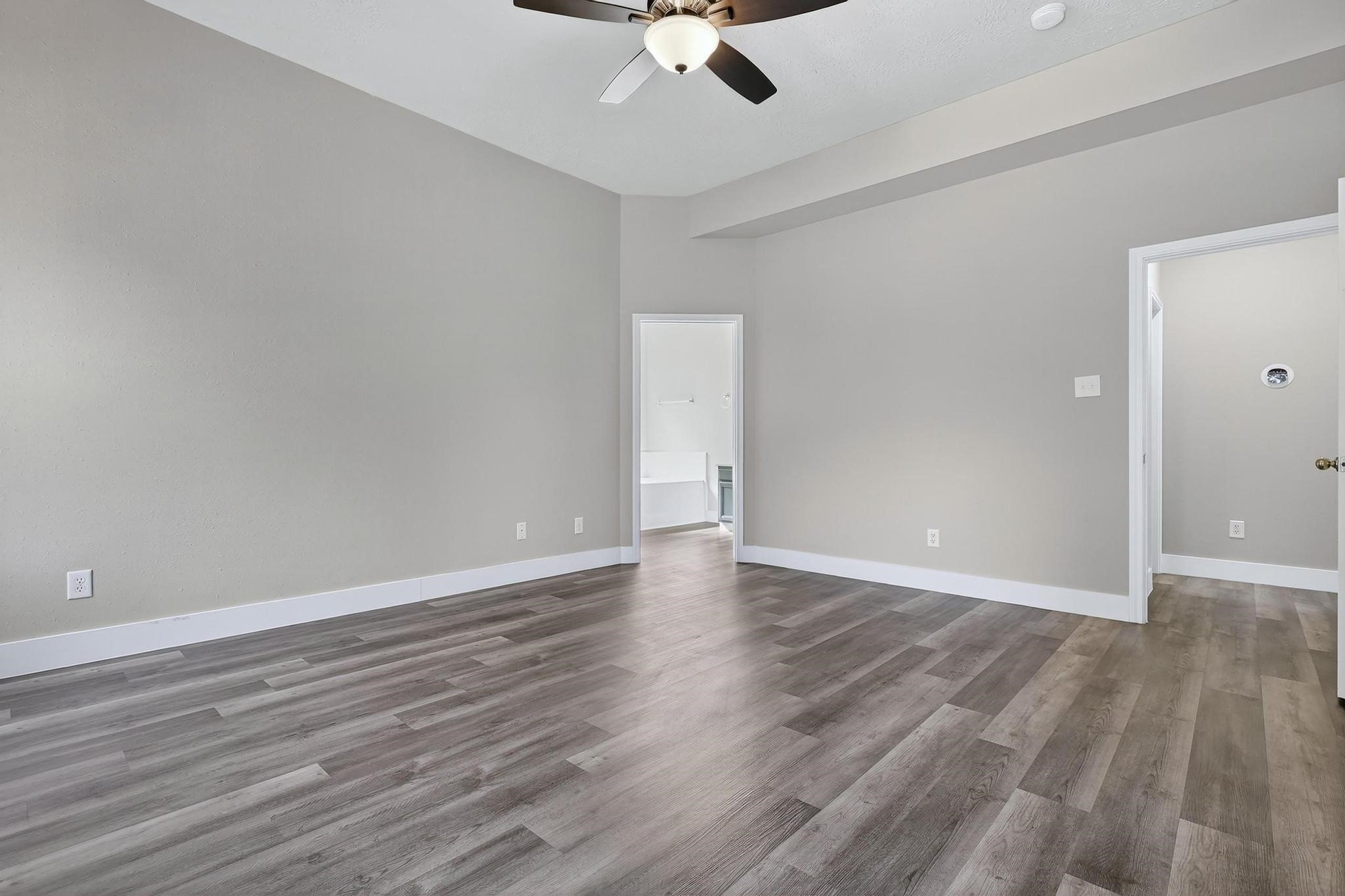 20926 Trellis Lane Houston, TX 77073 - Photo 7 of 24 an empty room with wooden floor ceiling fan and window