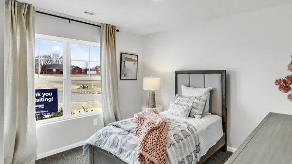 a bedroom with a bed and a mirror