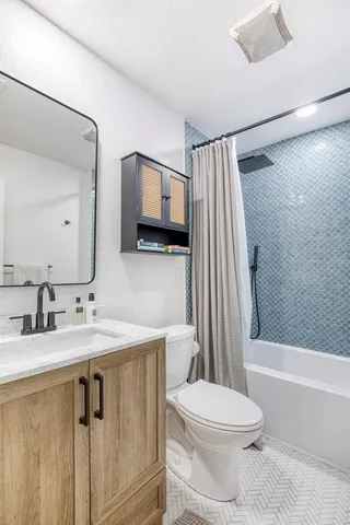 a bathroom with a sink a toilet and a mirror