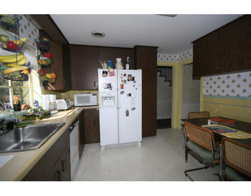 21 Whitney Road Newton, MA 02460 - Photo 5 of 14 a kitchen with stainless steel appliances a stove a sink and a refrigerator