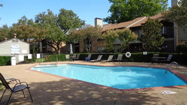 a view of a swimming pool with a patio