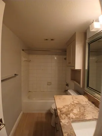 a bathroom with a tub and shower