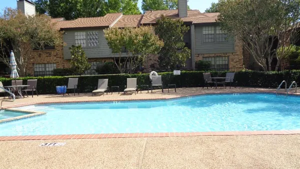 a view of swimming pool with outdoor seating and yard