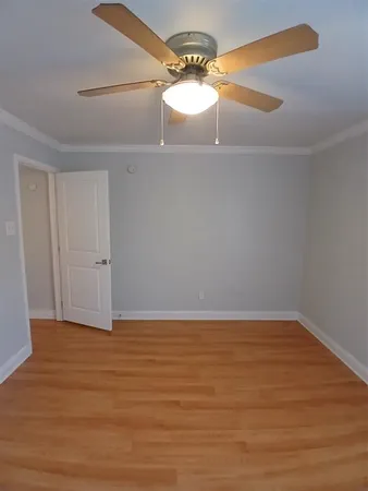 a view of a room with wooden floor