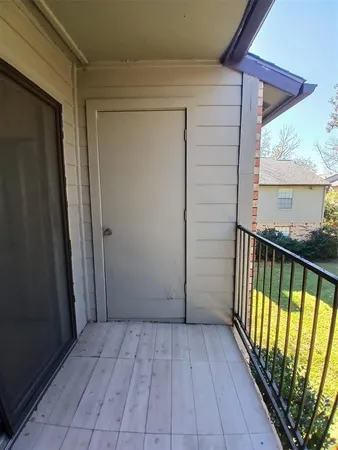 a view of a balcony with wooden floor