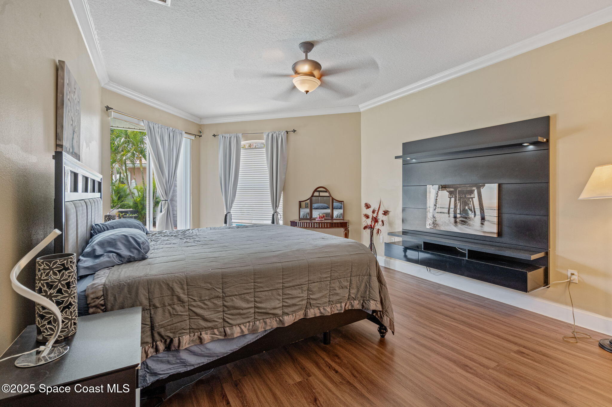 1835 Harbor Point Drive Merritt Island, FL 32952 - Photo 11 of 67 a bedroom with a bed and wooden floor